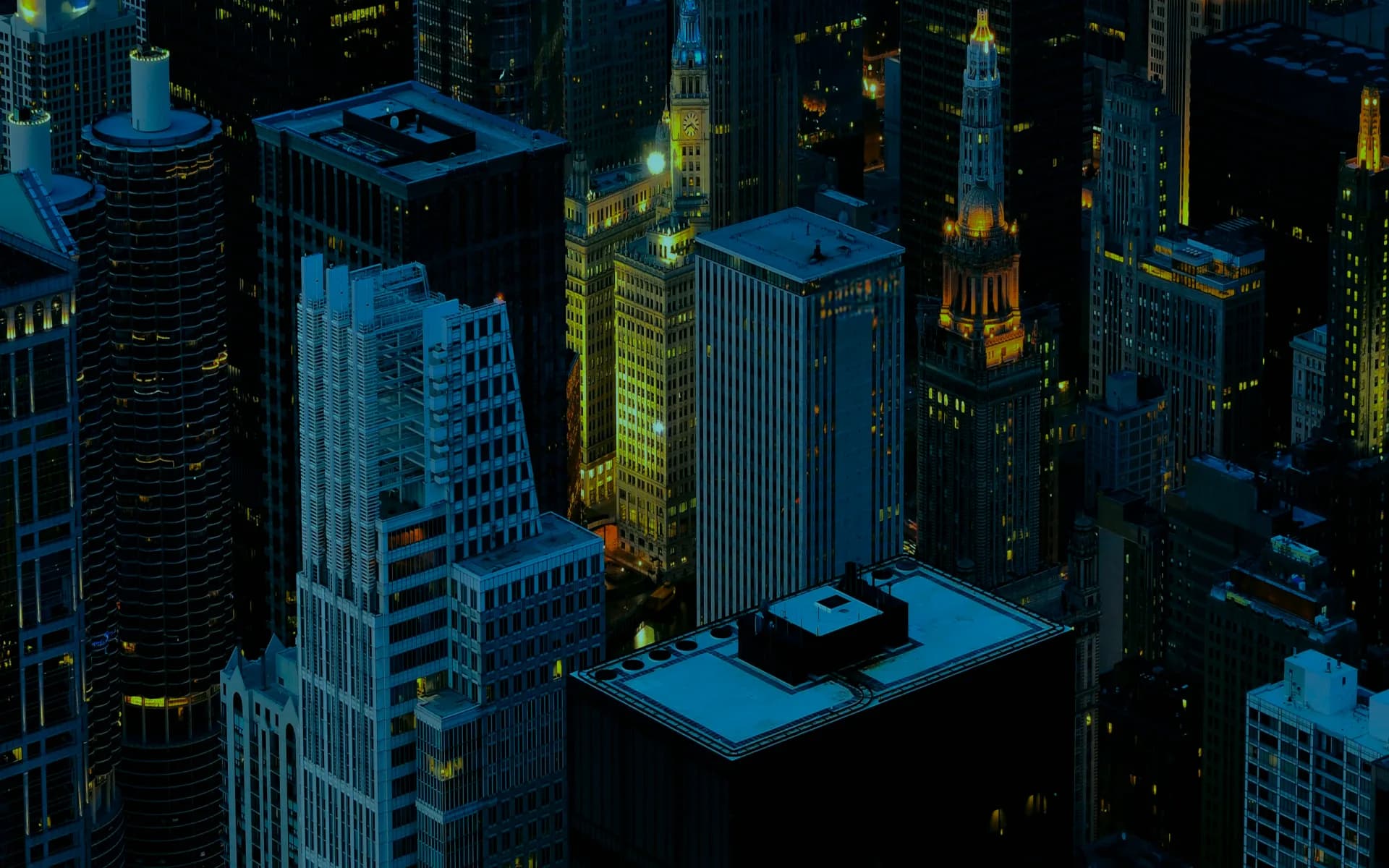 Office towers in a city centre at night, seen from above.