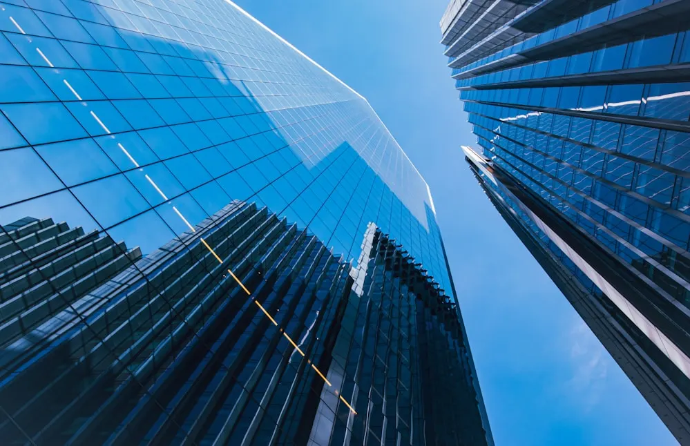 Glass office towers seen from below.