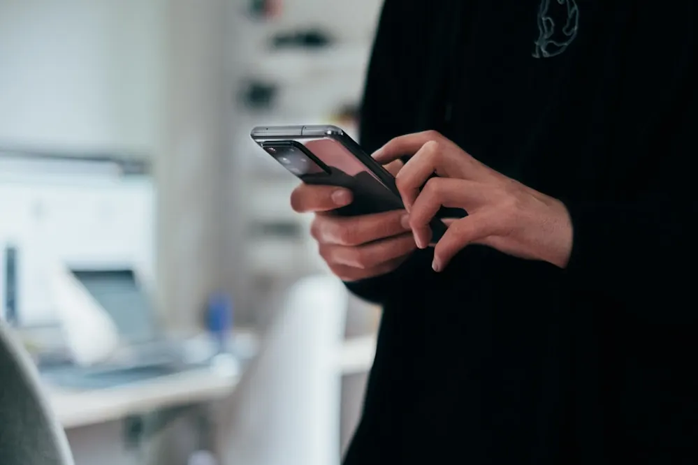A person holding a phone in both hands.
