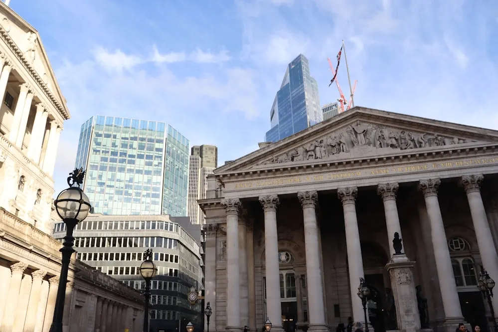 A classical exchange building beside modern towers.