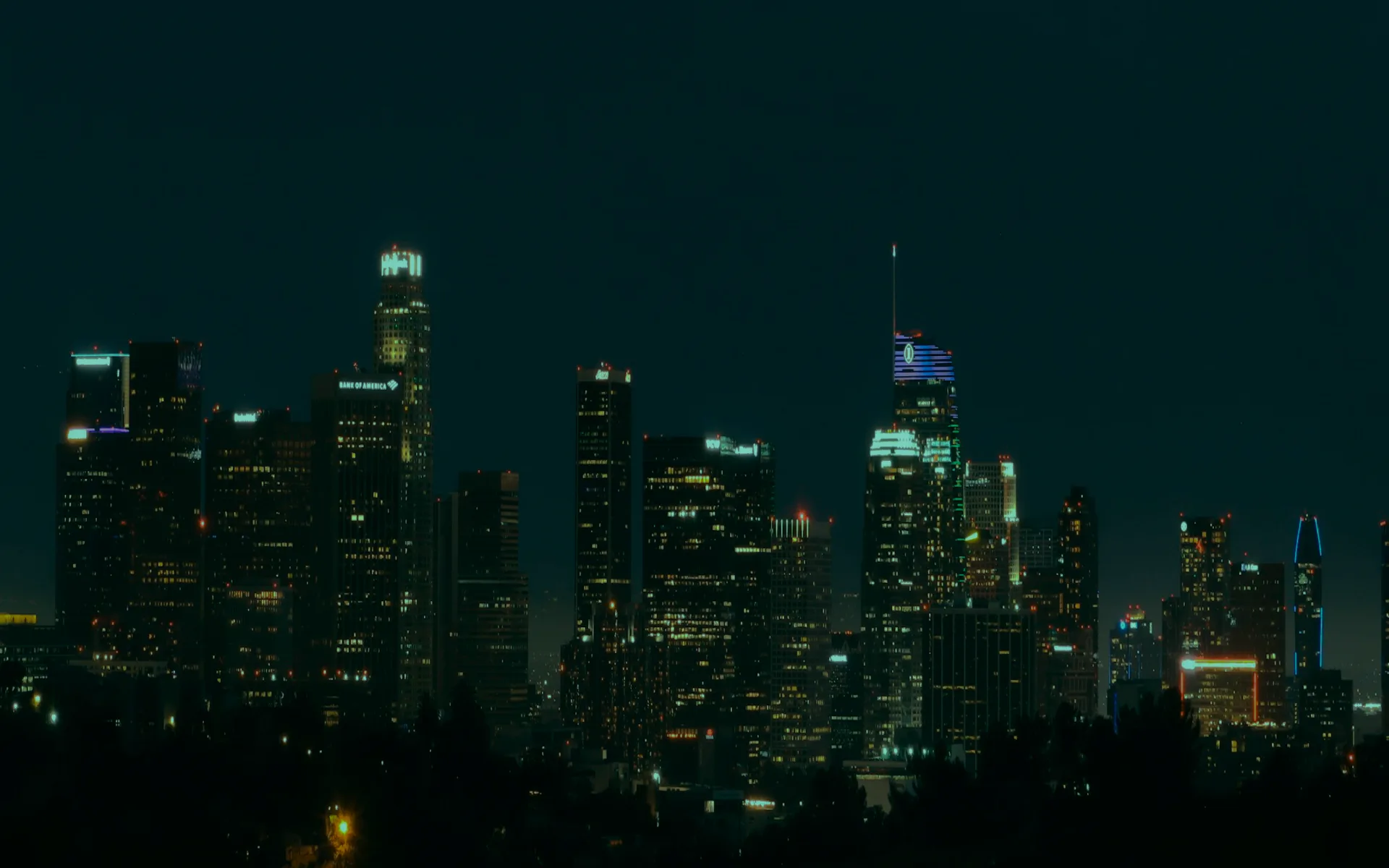 A city skyline at night under a dark sky.