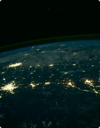 Earth from orbit at night with city lights.