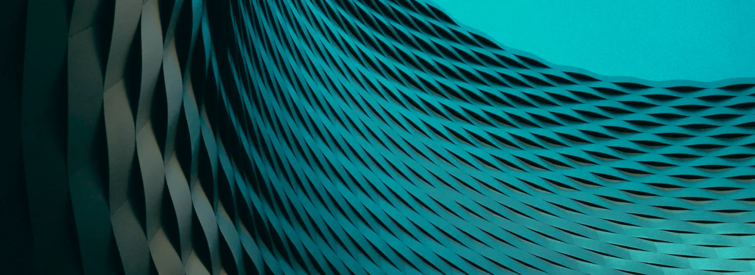 The curved woven facade of a building, seen from inside the curve.
