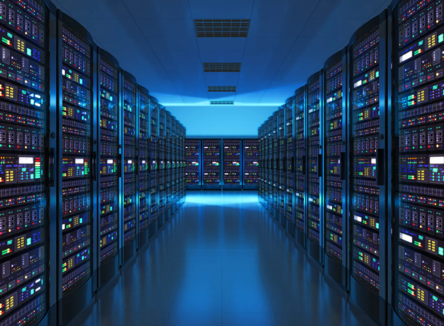A lit aisle between two rows of data-centre racks.