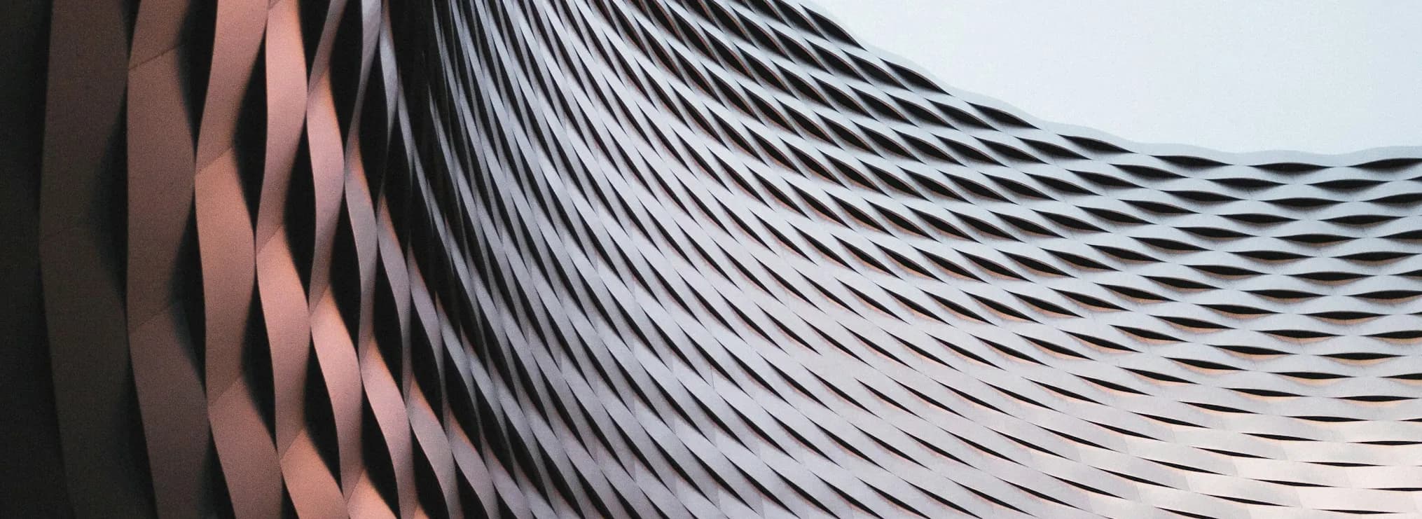 A rippled grey surface of overlapping ridges.