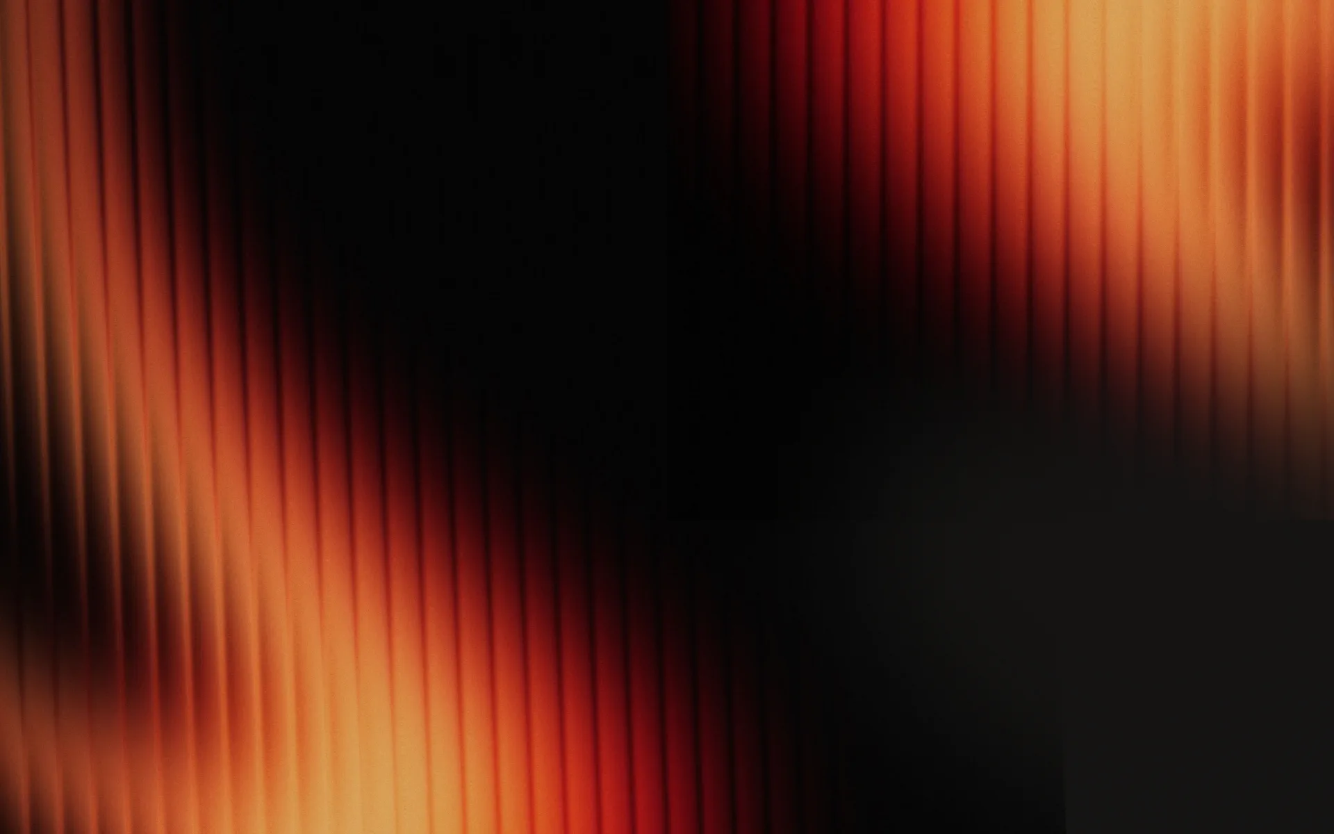 Fanned orange light bending across a dark ground.