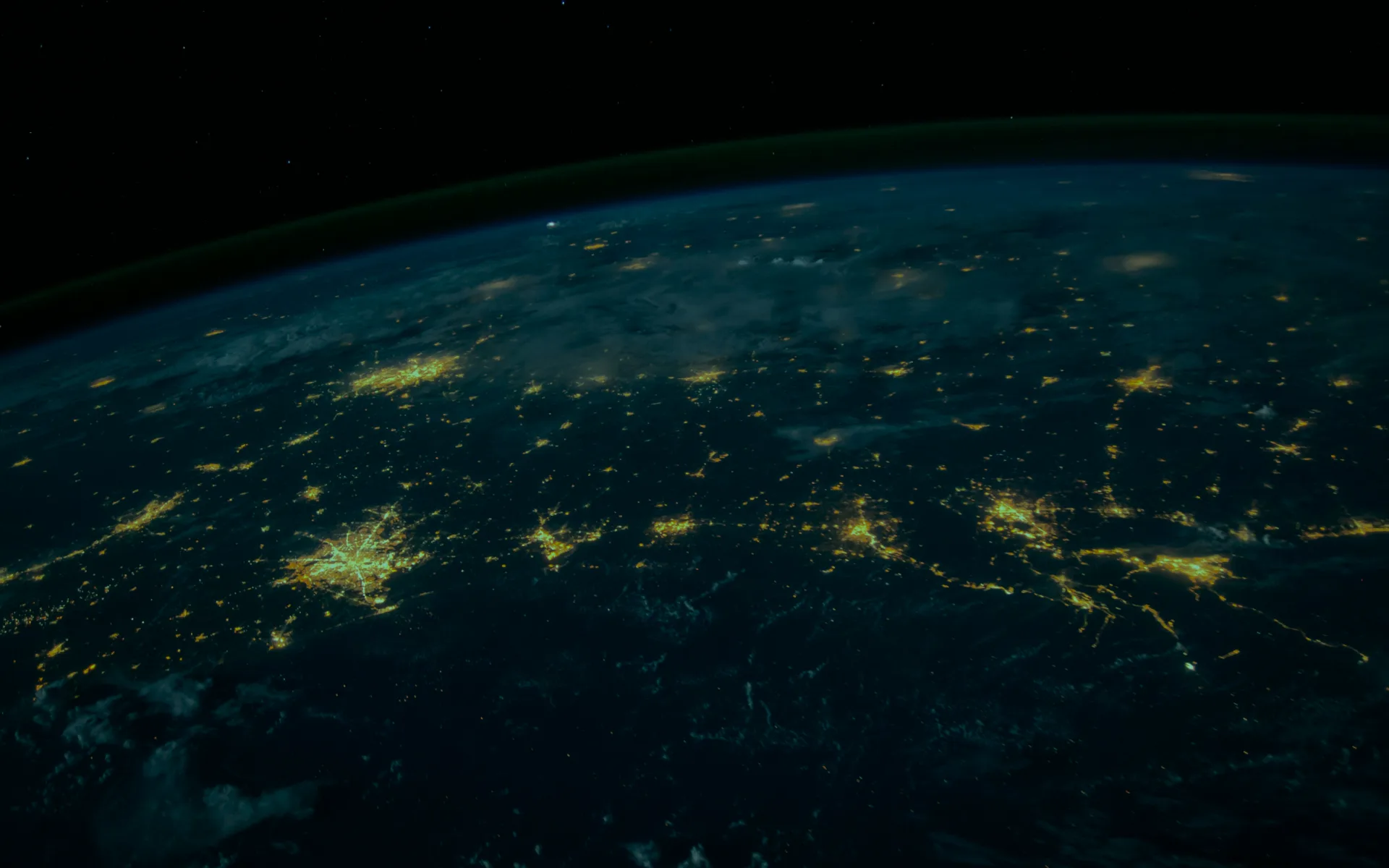 The curve of the Earth at night, city lights spread across it.