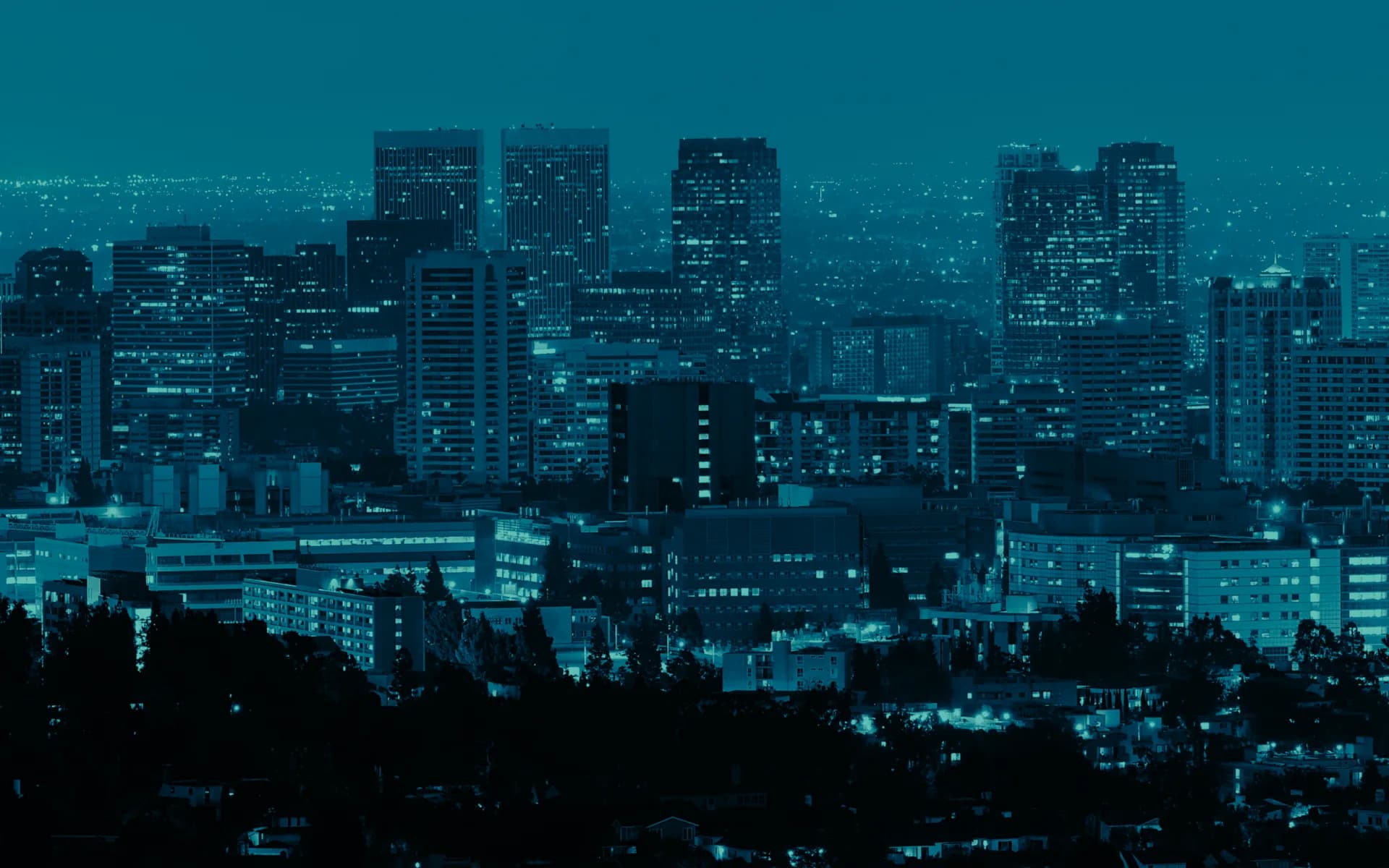 The Los Angeles skyline at night, lit from within.