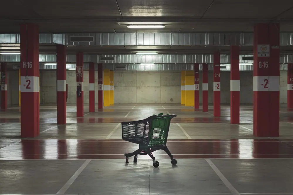 An empty parking level with a single trolley.