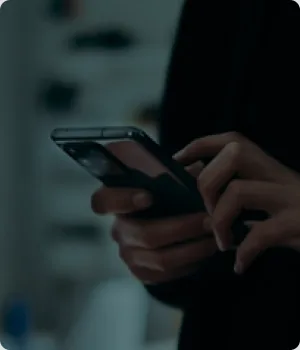 Hands hold a smartphone and touch the screen.