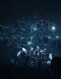Lit cubes suspended in a dark space.