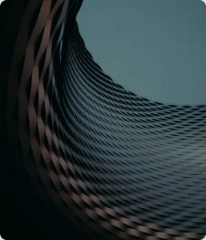 Curved building facade with a diagonal lattice pattern.