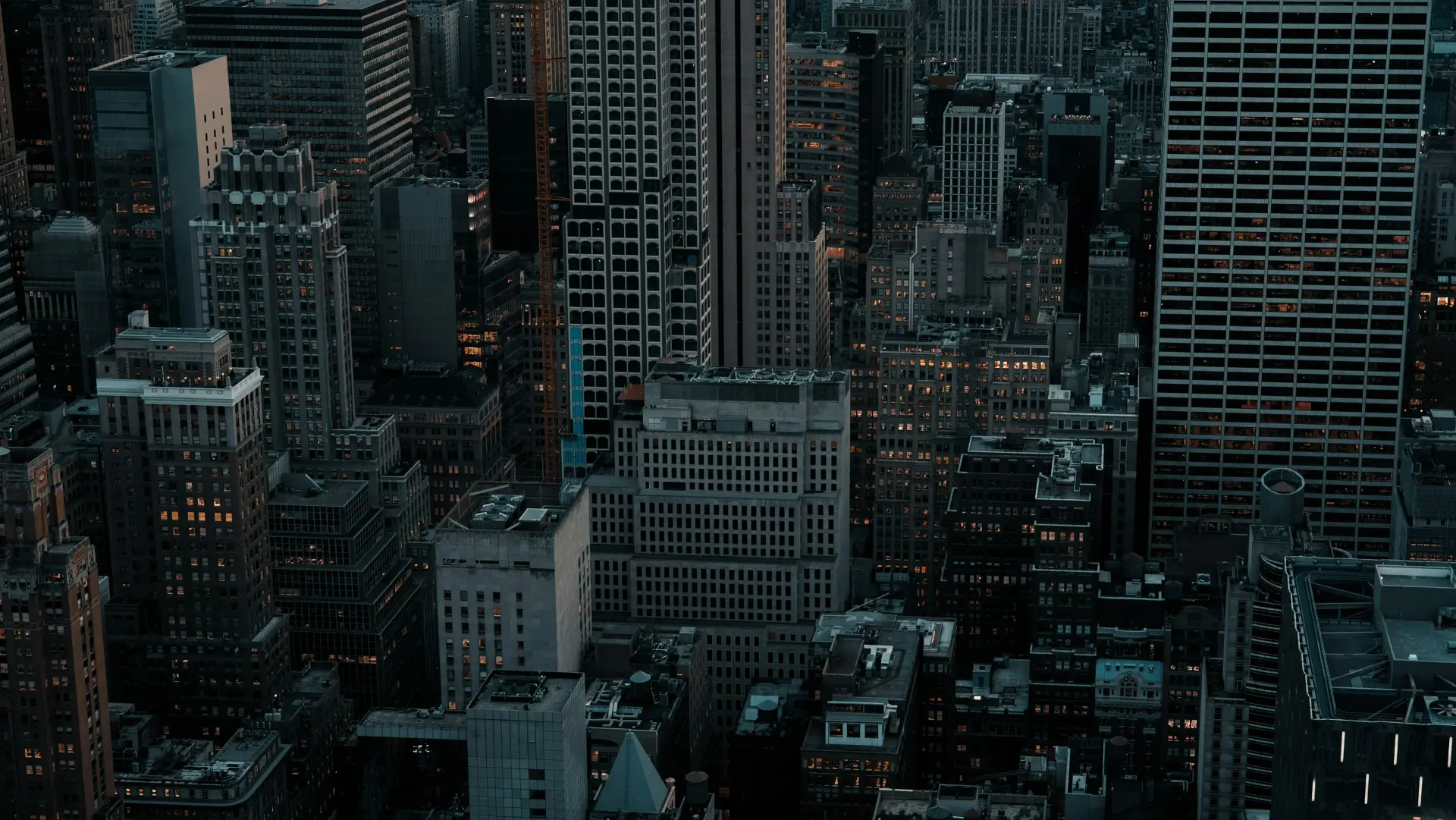 Midtown Manhattan office towers at dusk, seen from above.