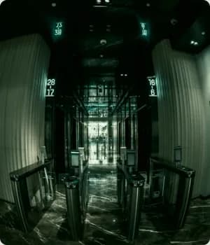 Security gates in a building lobby with numeric signs.