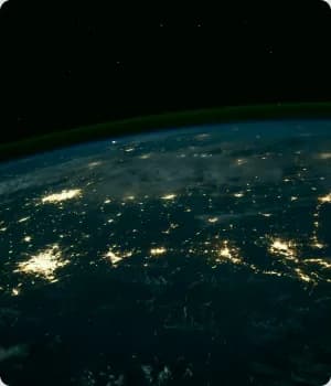 Earth from orbit at night with city lights.